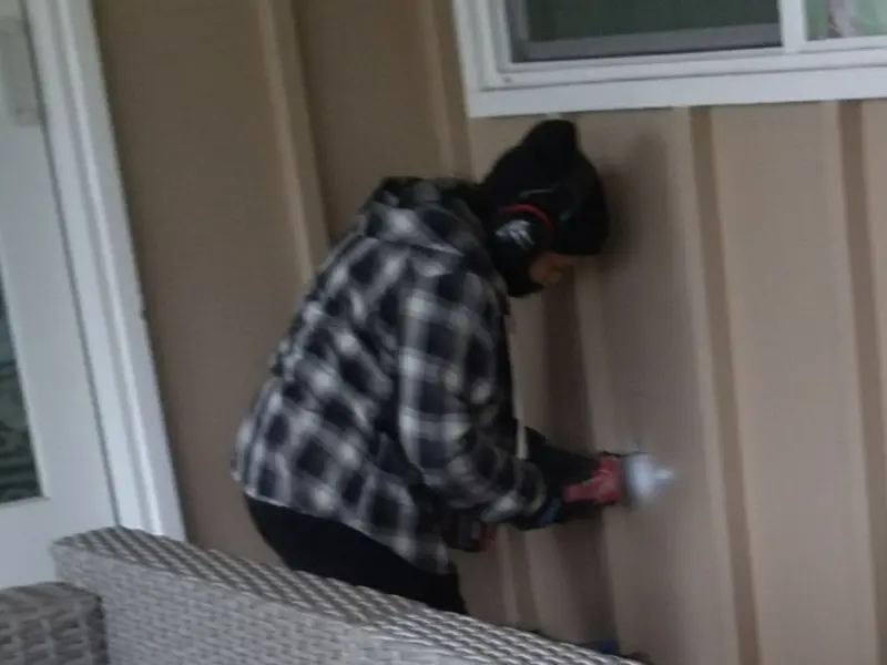 Professional electrician installing an exterior outlet in Morris