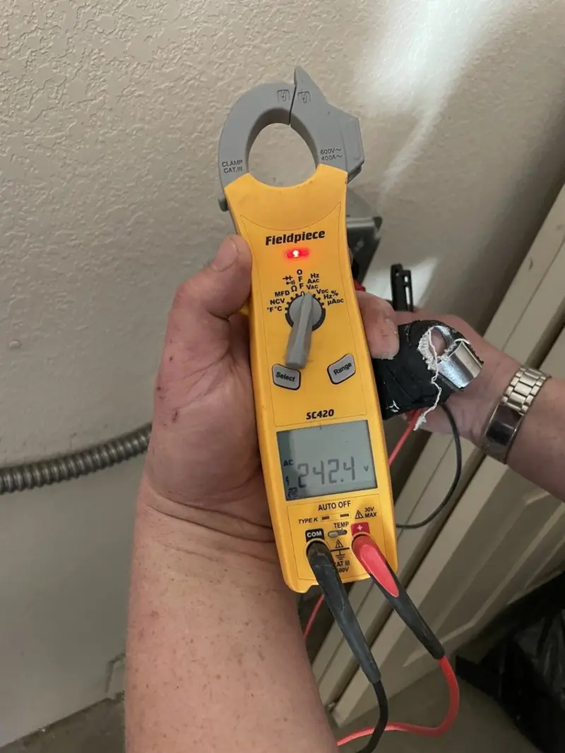 Voltage testing with clamp meter during Outlet Installation in Morris